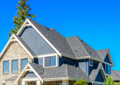Beautiful teal Florida home featuring a new architectural shingle roof, an example of durable hurricane resistant roofing for the Space Coast.